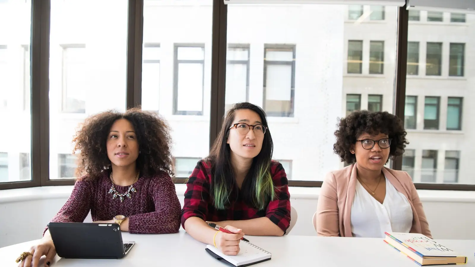 Three women at a boardroom table