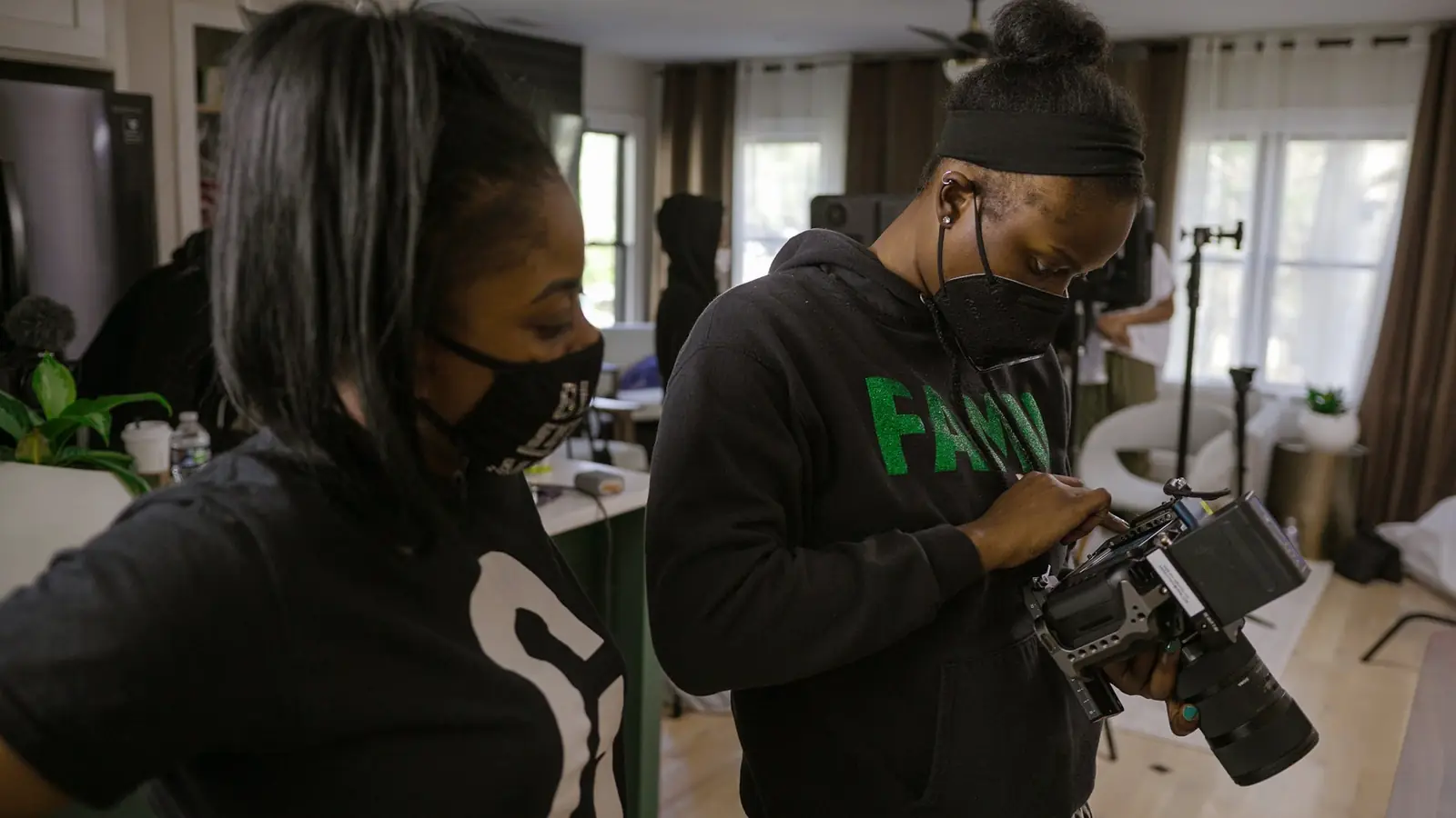 Two women working with a camera