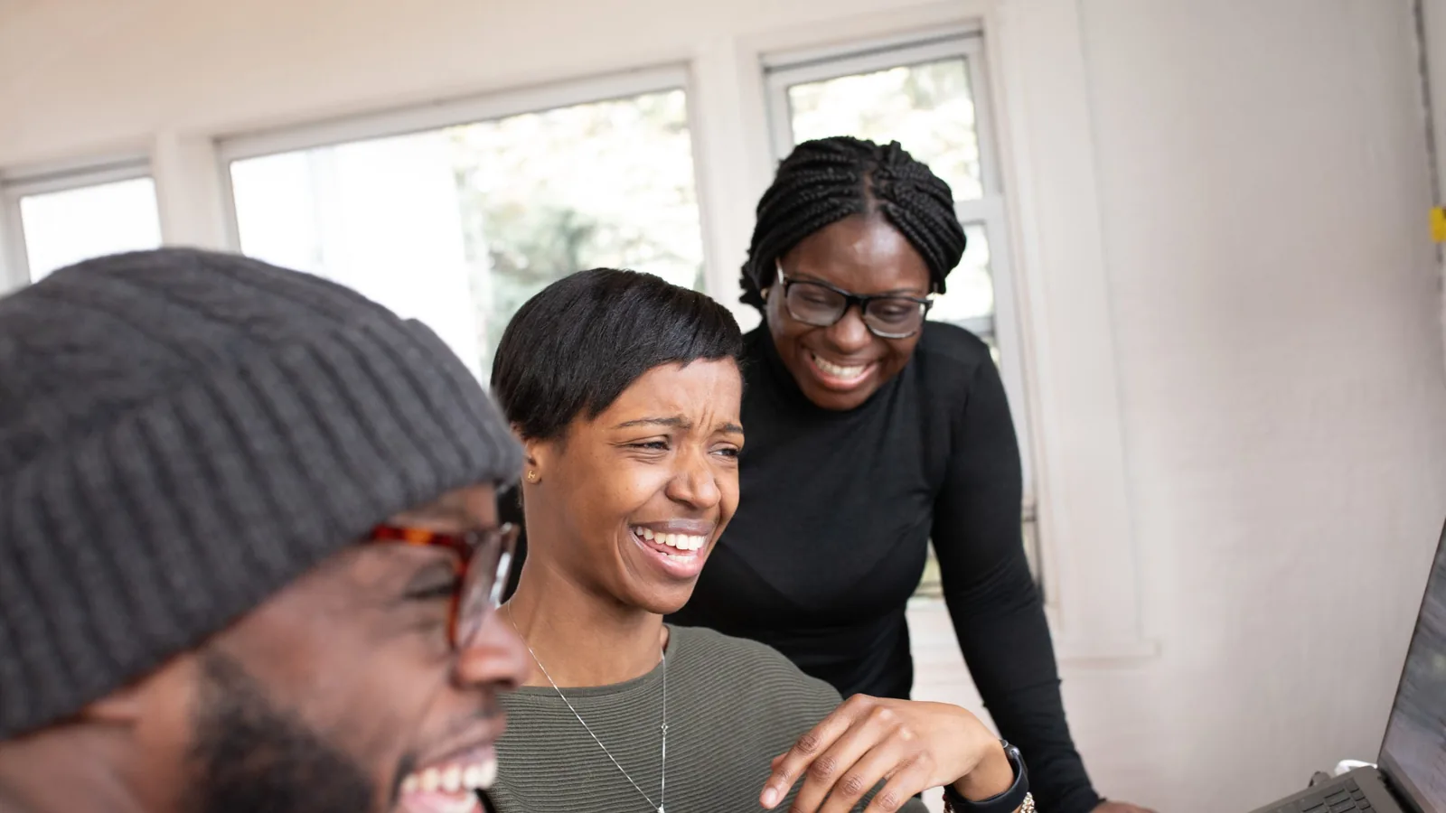Colleagues laughing together during a working session