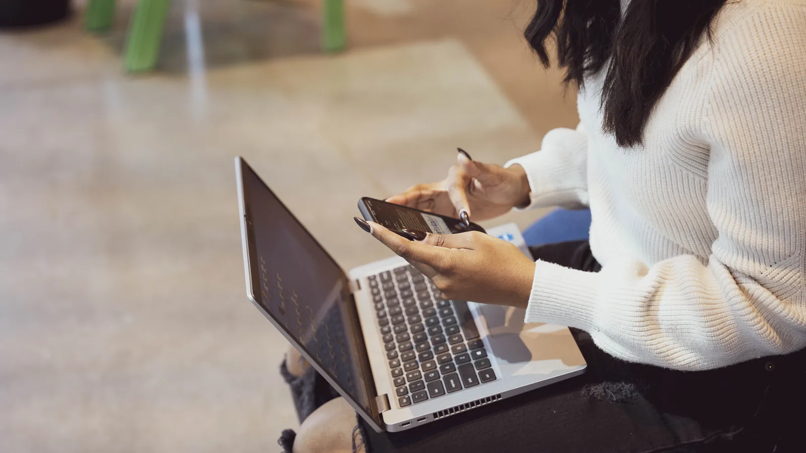 A founder working at a laptop with a notebook