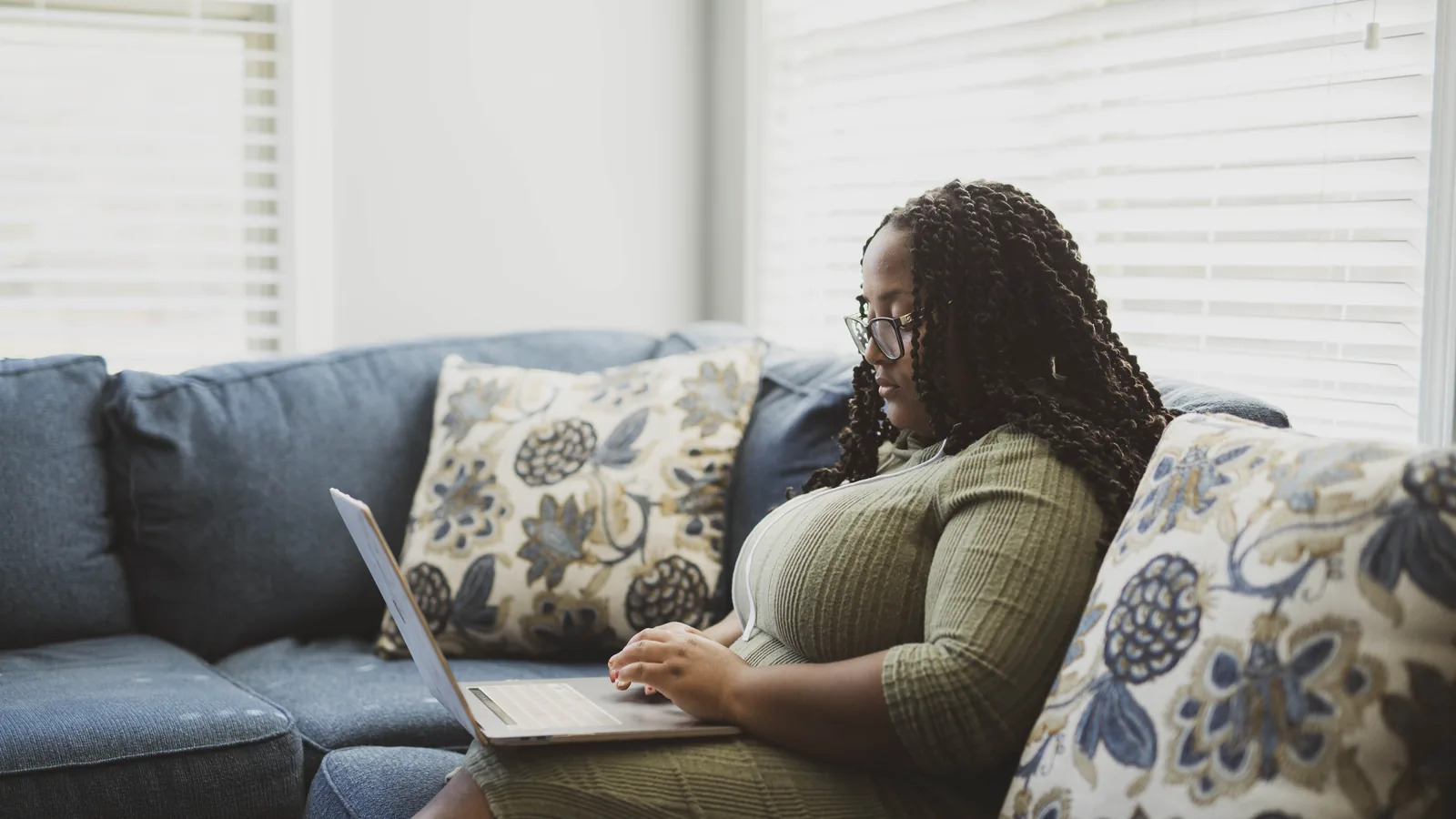 A professional working from a laptop at home