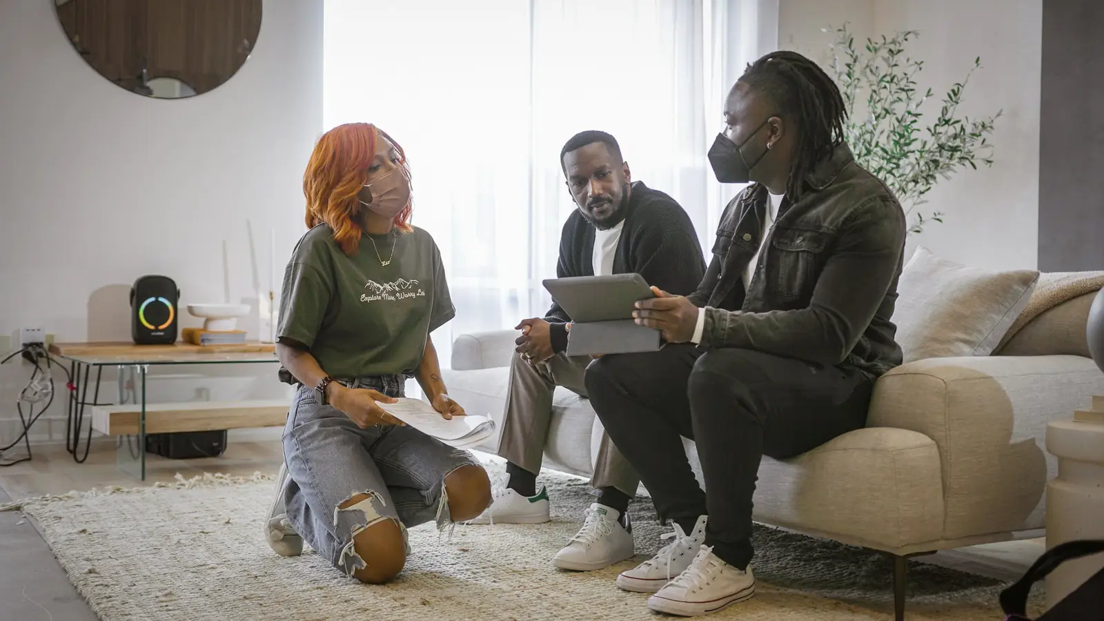 Three people reviewing something together on a tablet