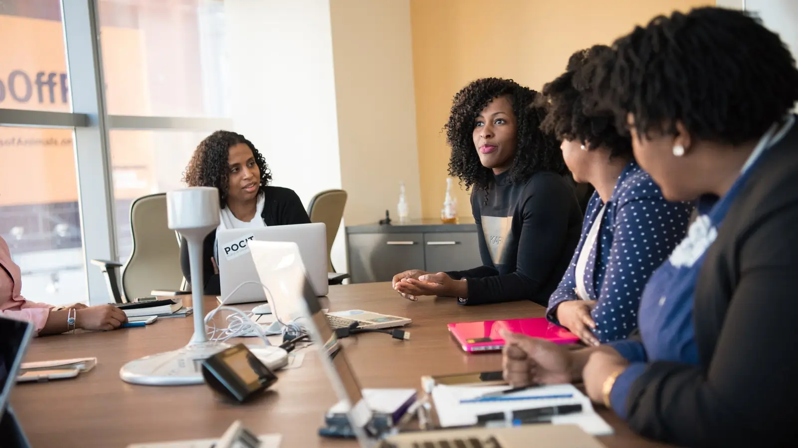 A group working along a long office table