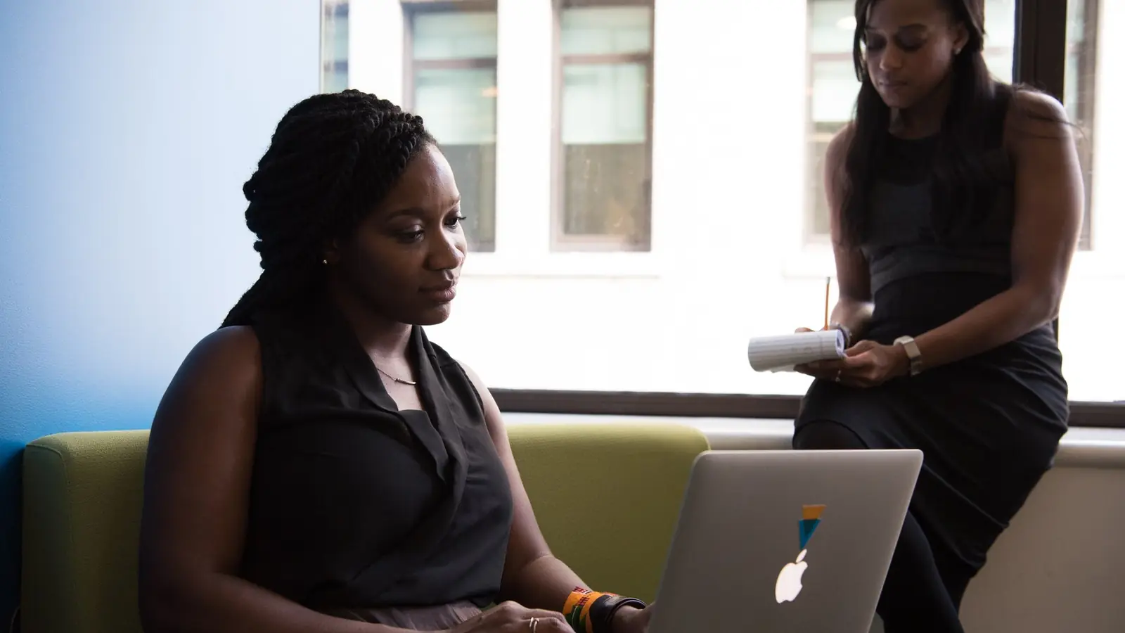 A woman working at a laptop in an office