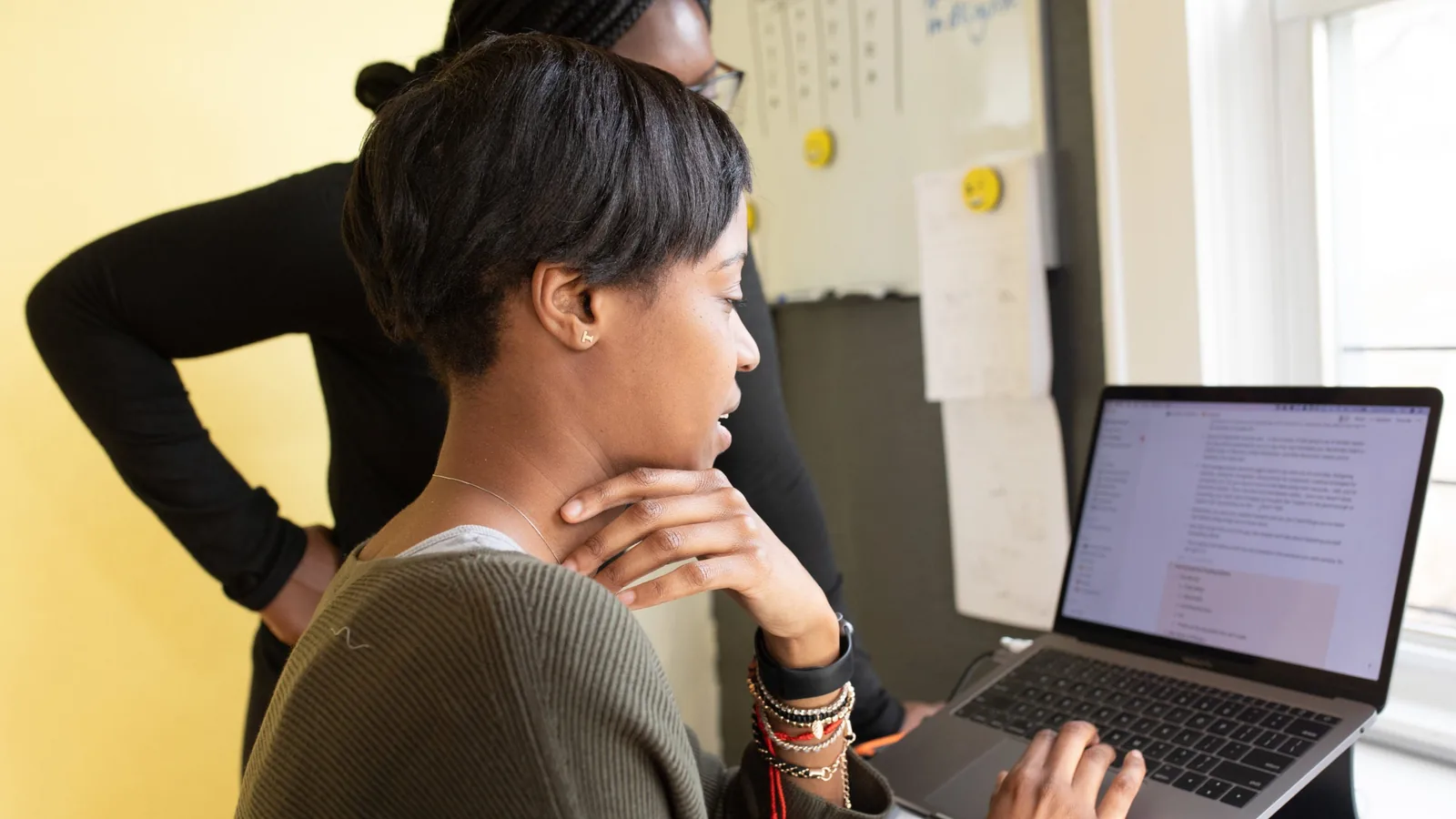 Two colleagues working side by side in an office