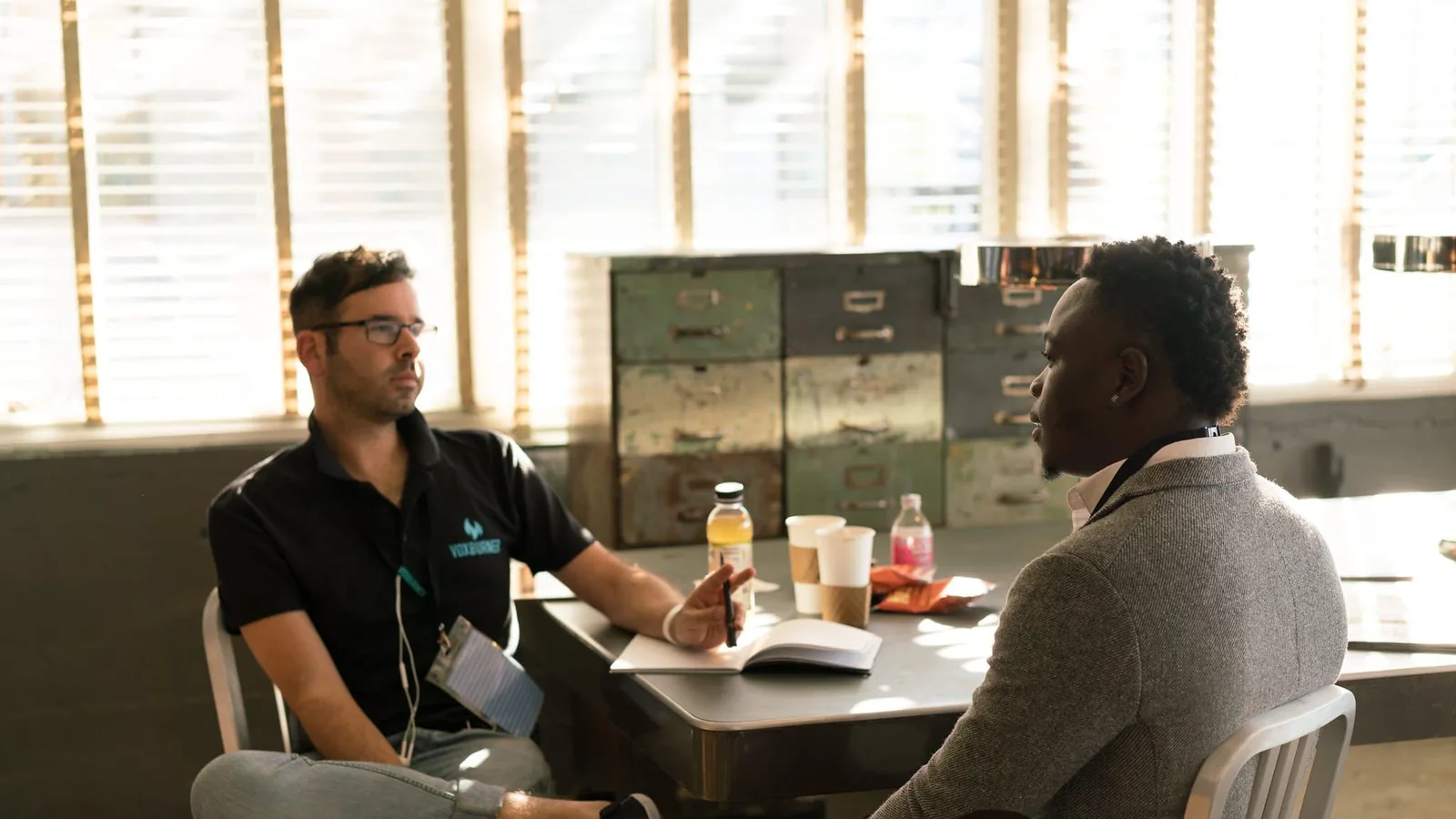 Two people in a one to one conversation at a table