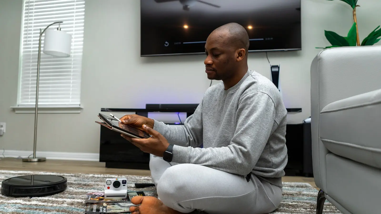 A man seated with a tablet