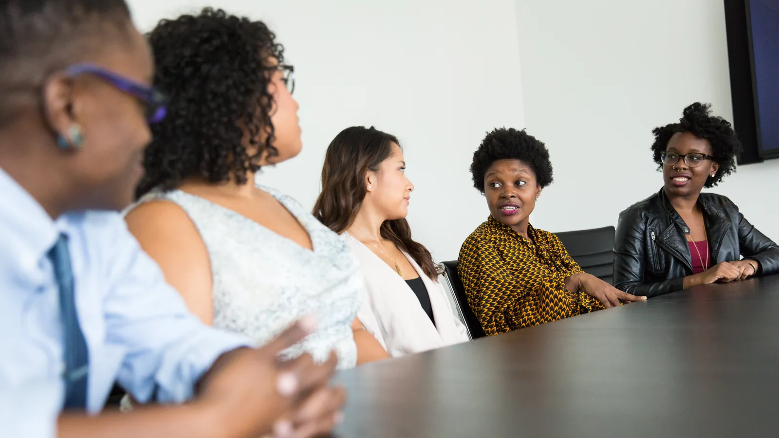A team seated around a conference table in discussion