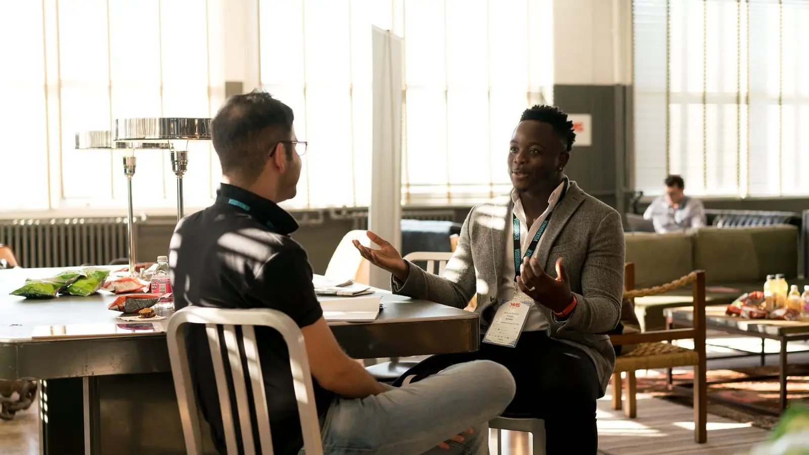 Two men talking across a table