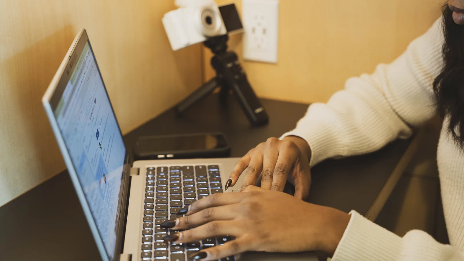 A professional typing at a desk